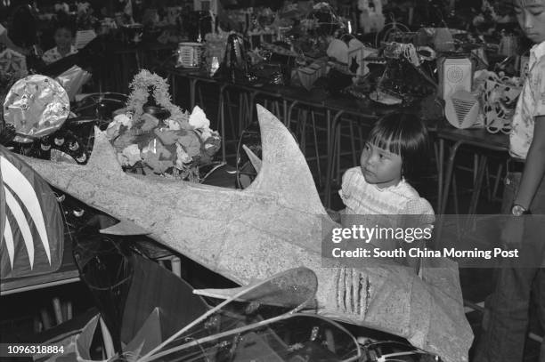 Little Nancy Ho looking at a shark-shaped lantern displayed in a lantern design competition. 16SEP78
