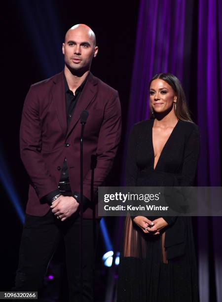 Mike Caussin and Jana Kramer presents onstage at the 2019 iHeartRadio Podcast Awards Presented by Capital One at the iHeartRadio Theater LA on...