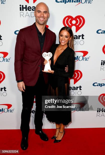 Winner Mike Caussin and Jana Kramer pose in the press room at the 2019 iHeartRadio Podcast Awards Presented by Capital One at the iHeartRadio Theater...