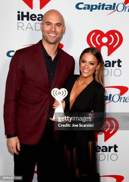 Winner Mike Caussin and Jana Kramer pose in the press room at the 2019 iHeartRadio Podcast Awards Presented by Capital One at the iHeartRadio Theater...