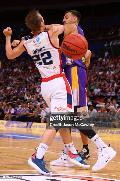 Anthony Drmic of the 36ers is fouled by Andrew Bogut of the Kings during the round 14 NBL match between the Sydney Kings and the Adelaide 36ers at...