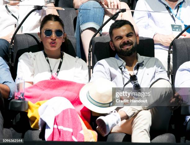 In this handout image provded by Tennis Australia, Virat Kohli and wife Anushka Sharma watch the action on Rod Laver Arena during the 2019 Australian...