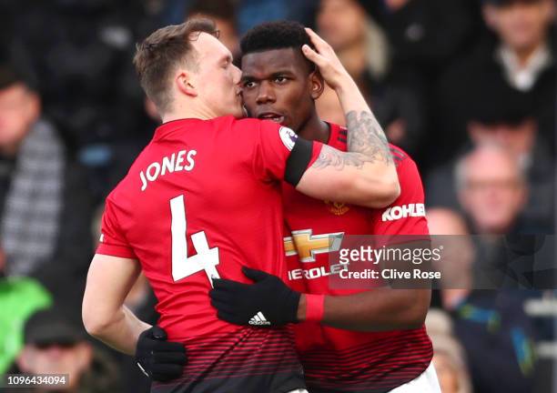 Paul Pogba of Manchester United celebrates with teammate Phil Jones after scoring his team's first goal during the Premier League match between...