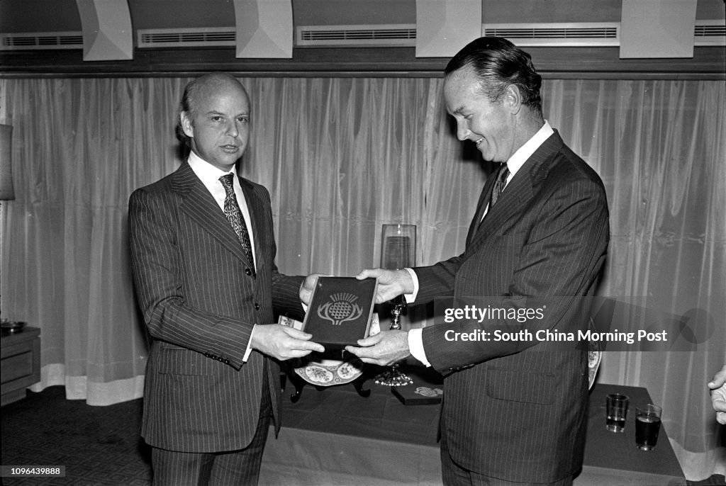 David Newbigging (right), Chairman of Jardine Matheson, presenting a souvenir to his staff, Jeremy Brown, at the farewell party of Mr Brown. 15DEC78