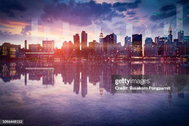 business background with stock graph growth on the city skyline view. - new york skyline nacht stock-fotos und bilder