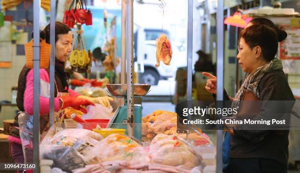 Poultry vendor selling live chickens at wet market in Kowloon City. 30DEC16 SCMP / Dickson Lee