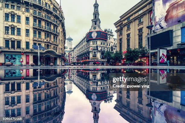 shanghai nanjing road with reflection in the water - lakeside shopping centre stock pictures, royalty-free photos & images