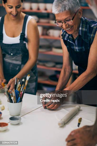 seniors ceramic workshop working with instructor - ceramic stock pictures, royalty-free photos & images