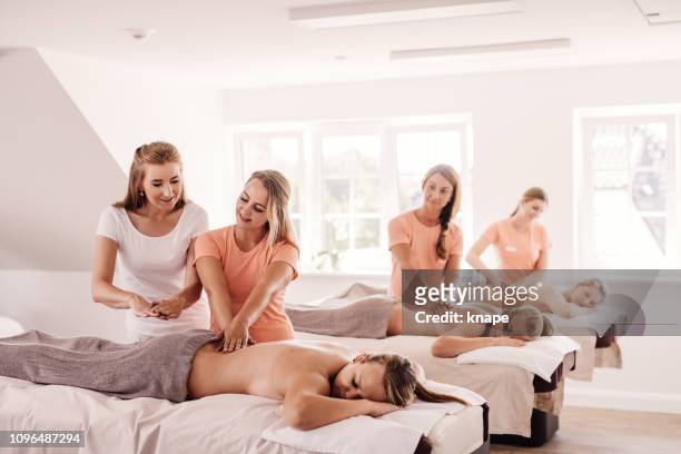 women in beautician class learning to be massage therapists - massage stock pictures, royalty-free photos & images
