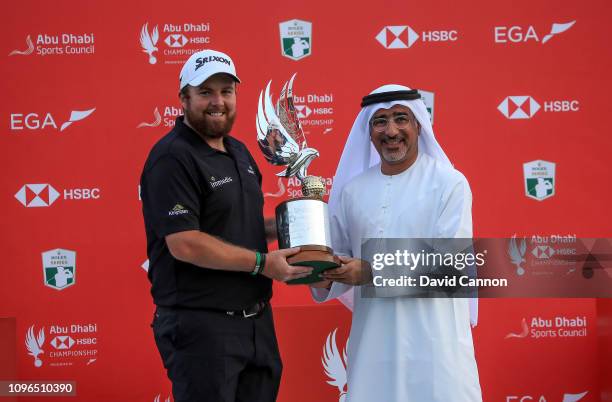 Shane Lowry of Ireland his presented with the trophy by Abdulfattah Sharaf the CEO of HSBC in Dubai after his one shot win during the final round of...