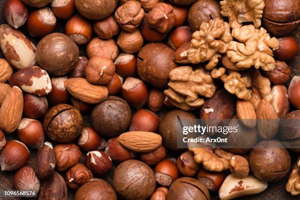 group of nuts as background - peanut food stock pictures, royalty-free photos & images