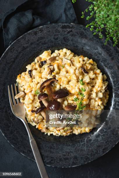 mushroom risotto or pearl barley risotto with mushrooms - risotto stock pictures, royalty-free photos & images