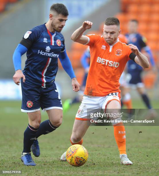 Blackpool's Oliver Turton vies for possession with Walsall's Joe Edwards during the Sky Bet League One match between Blackpool and Walsall at...