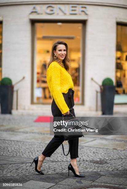 Alexandra Lapp is seen wearing a cropped yellow cable knit sweater from R13 with paperbag pants from H&M, Gianvito Rossi patent leather pumps, Zara...