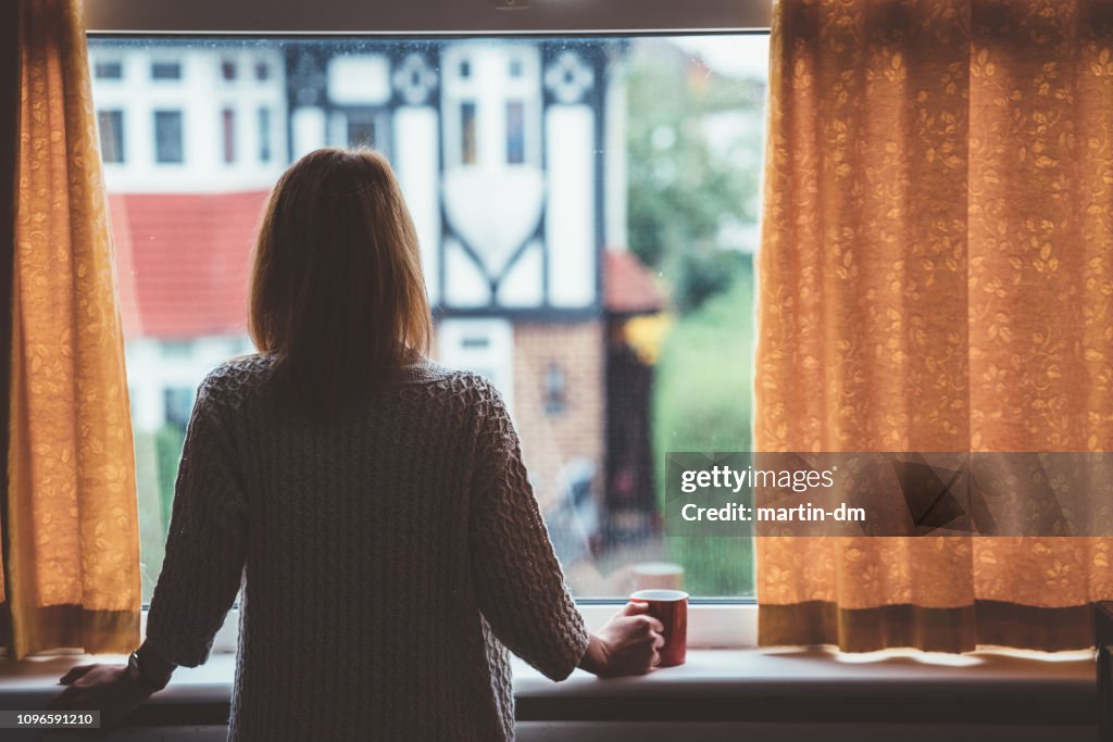 Woman drinking tea at home