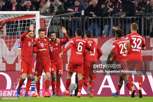 Robert Lewandowski of Bayern Munich celebrates after scoring his team's first goal with his team mates during the Bundesliga match between FC Bayern...