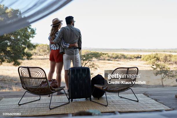 couple arriving at amazing cabin in the wild and enjoying the view - safari lodge stock pictures, royalty-free photos & images