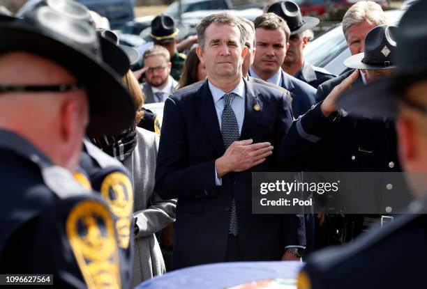 Virginia Gov. Ralph Northam watches as the casket of fallen Virginia State Trooper Lucas B. Dowell is carried to a waiting tactical vehicle during...