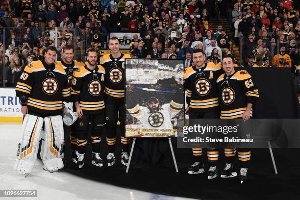 Patrice Bergeron of the Boston Bruins poses with team mates Tuukka Rask, David Backes, David Krejci, Zdeno Chara and Brad Marchand with a photo...