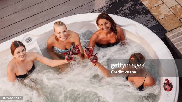 group of young women having fun in hot tub whirlpool outdoors - hot tub party stock pictures, royalty-free photos & images
