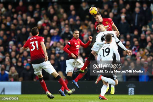 Phil Jones of Manchester United wins a header from Aleksandar Mitrovic of Fulham during the Premier League match between Fulham FC and Manchester...