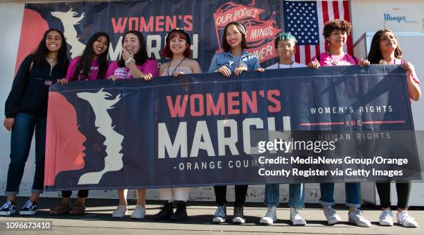 Women pose with a banner after the Orange County Women's March in Santa Ana on Saturday, January 19, 2019.