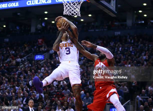 Kelly Oubre Jr. #3 of the Phoenix Suns shoots the ball as C.J. Miles of the Toronto Raptors defends during the first half of an NBA game at...