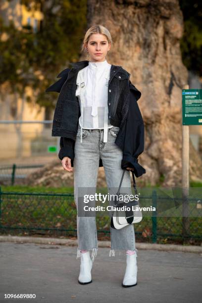 Caro Daur, wearing a white shirt, black denim jacket, grey jeans and black, white boots and white Prada bag, is seen in the streets of Paris before...