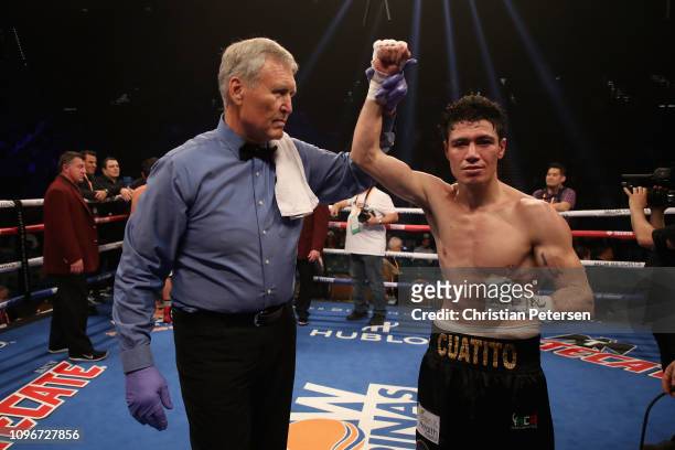 Hugo Ruiz celebrates his win by majority decision over Alberto Guervara with referee Jay Nady during the featherweight fight at MGM Grand Garden...