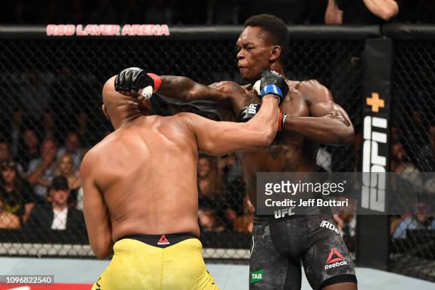 Israel Adesanya of New Zealand and Anderson Silva of Brazil exchange punches in their middleweight bout during the UFC 234 at Rod Laver Arena on...