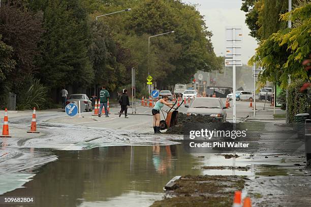 People work in the suburb of Shirley to clear away silt caused as a result of liquefaction on March 01, 2011 in Christchurch, New Zealand. The death...