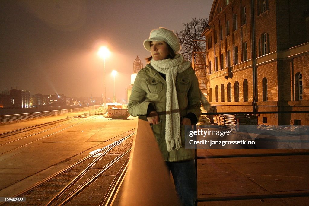Night-portrait of a woman in an industrial area