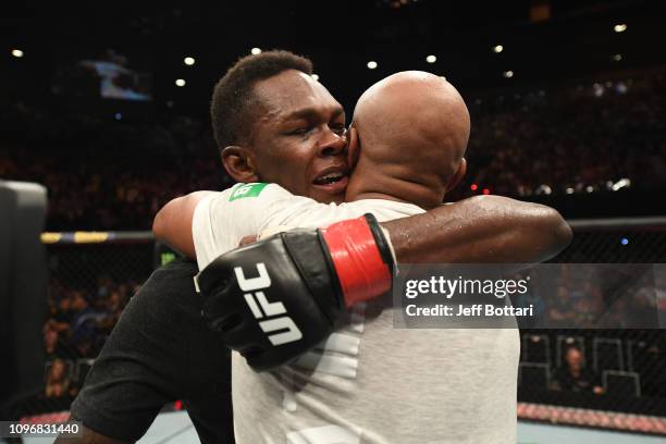 Israel Adesanya of New Zealand and Anderson Silva of Brazil hug after their middleweight bout during the UFC 234 at Rod Laver Arena on February 10,...