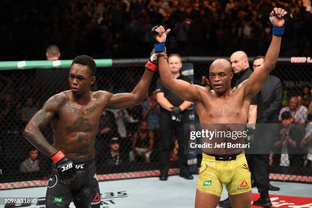 Anderson Silva of Brazil and Israel Adesanya of New Zealand react after the conclusion of their middleweight bout during the UFC 234 at Rod Laver...