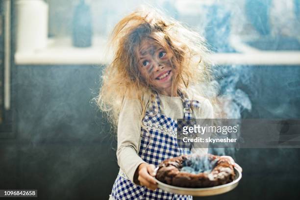 whops, i have burnt the cake! - children misbehaving stock pictures, royalty-free photos & images