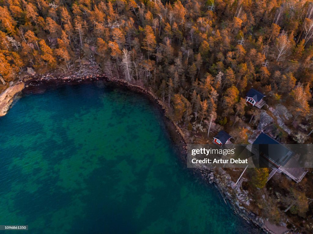 Aerial view of red houses with the sea and nature in the Stockholm archipelago.