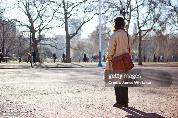 city worker looks to the future - trench coat back stock pictures, royalty-free photos & images