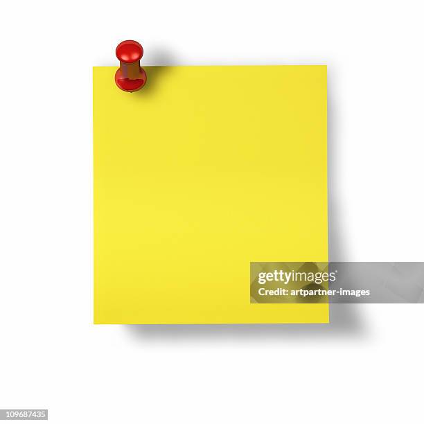 yellow memo, notes or post-it with red pin - postit stockfoto's en -beelden