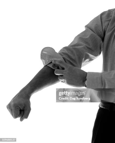 tucking up the sleeves - roll shirt stock pictures, royalty-free photos & images