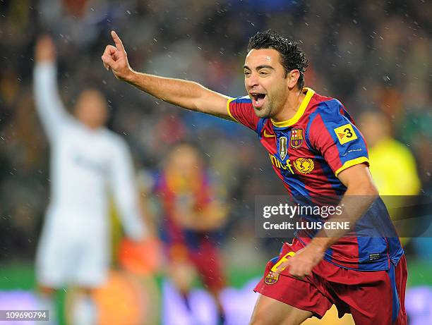 Barcelona's midfielder Xavi Hernandez celebrates after scoring against Real Madrid during the Spanish league "clasico" football match FC Barcelona vs...