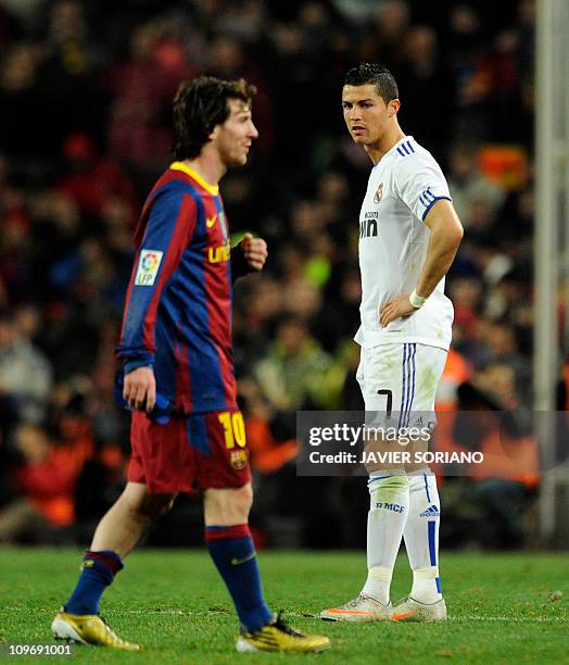 Real Madrid's Portuguese forward Cristiano Ronaldo looks at Barcelona's Argentinian forward Lionel Messi during the Spanish league "clasico" football...