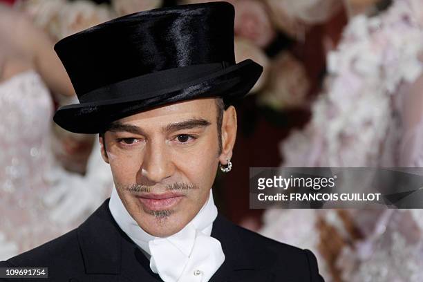 British designer John Galliano acknowledges the audience following the Christian Dior spring-summer 2010 haute couture collection show on January 25,...