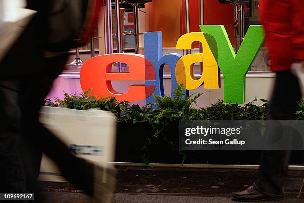 Visitors walk past the logo of online retailer eBay at the CeBIT technology trade fair on March 1, 2011 in Hanover, Germany. CeBIT 2011 will be open...