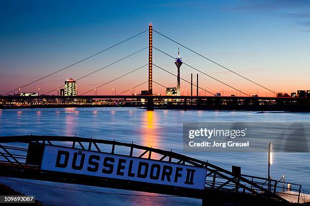 düsseldorf skyline and rhine river at dusk - düsseldorf skyline stock-fotos und bilder