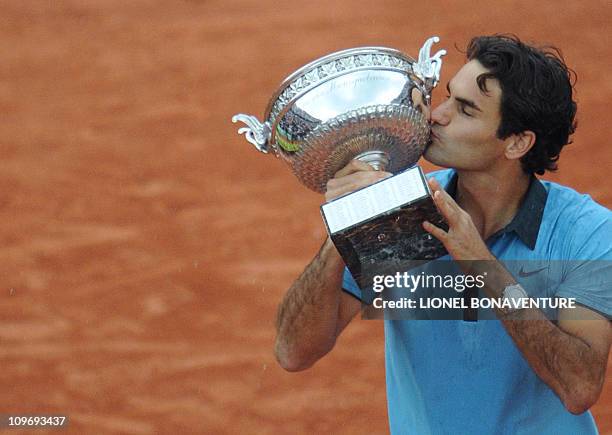 Swiss Roger Federer kisses the trophy after winning against Swedish player Robin Soderling during their French Open tennis men's final match on June...