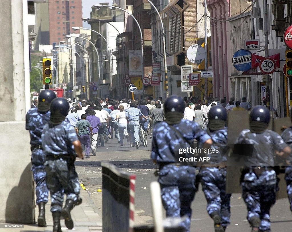 Anti-riot police charge protestors 19 De