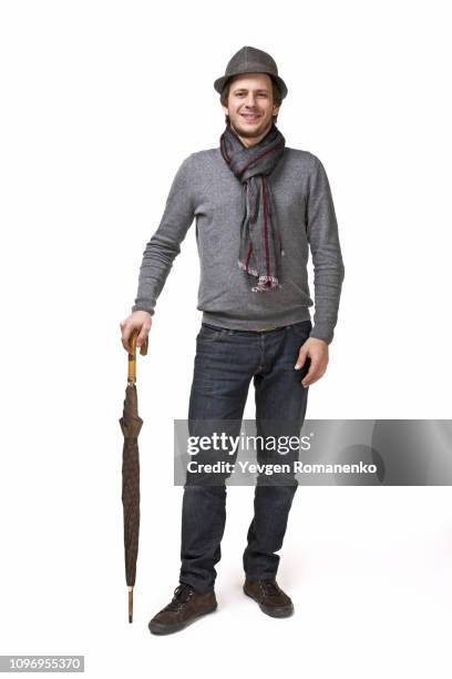 smiling man in scarf and hat, standing on white background with umbrella - man full length isolated stock pictures, royalty-free photos & images