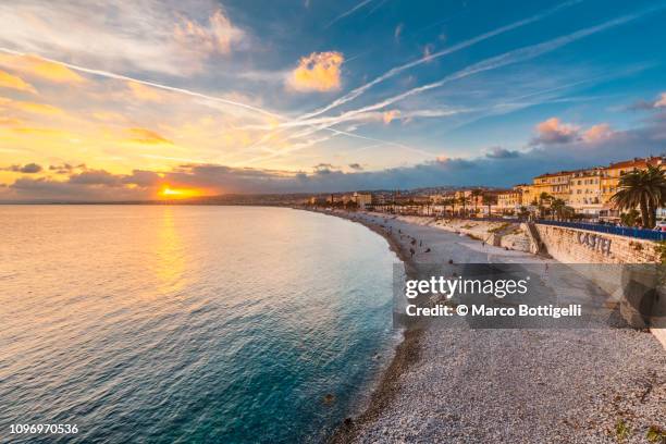 promenade des anglais at sunset, nice, french riviera - nice promenade des anglais photos et images de collection