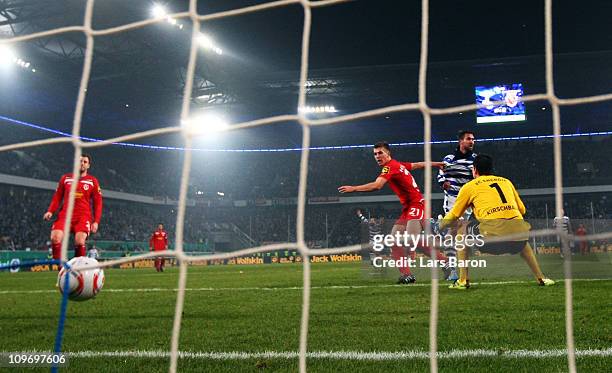 Stefan Maierhofer of Duisburg heads his teams first goal past goalkeeper Thorsten Kirschbaum of Cottbus during the DFB Cup semi final match between...