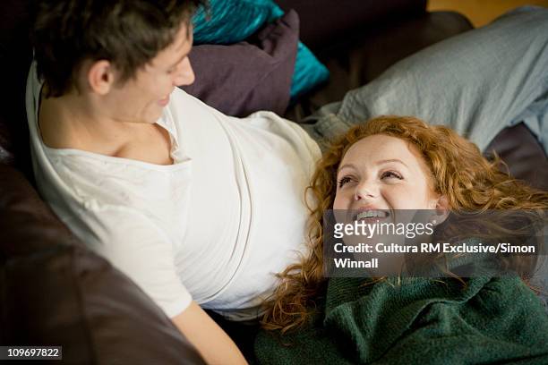 couple relaxing on sofa - stourbridge stock pictures, royalty-free photos & images